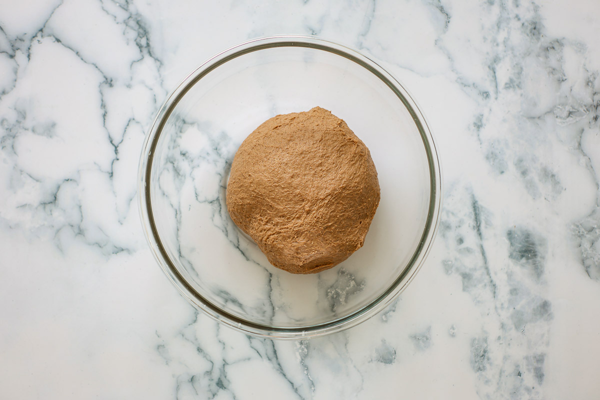 Dough before bulk fermentation, in a glass bowl.