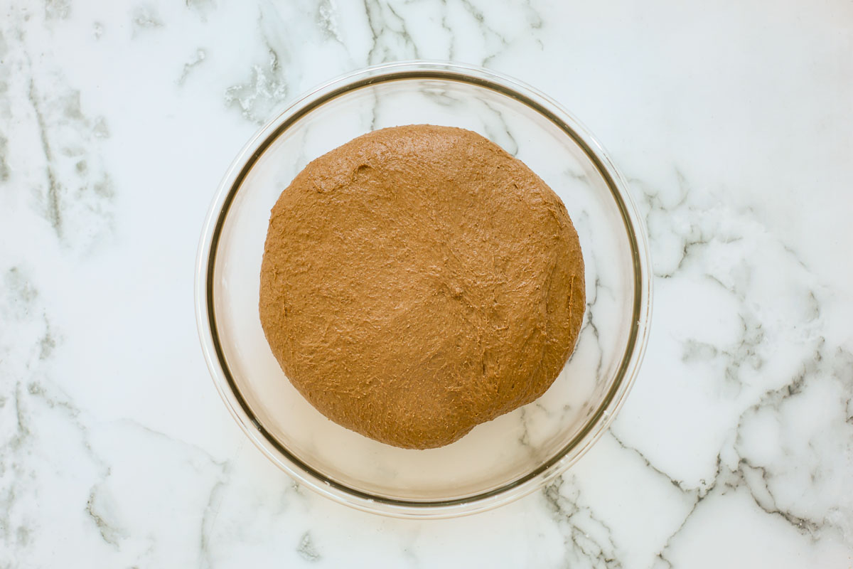 Dough after bulk fermentation, in a glass bowl.