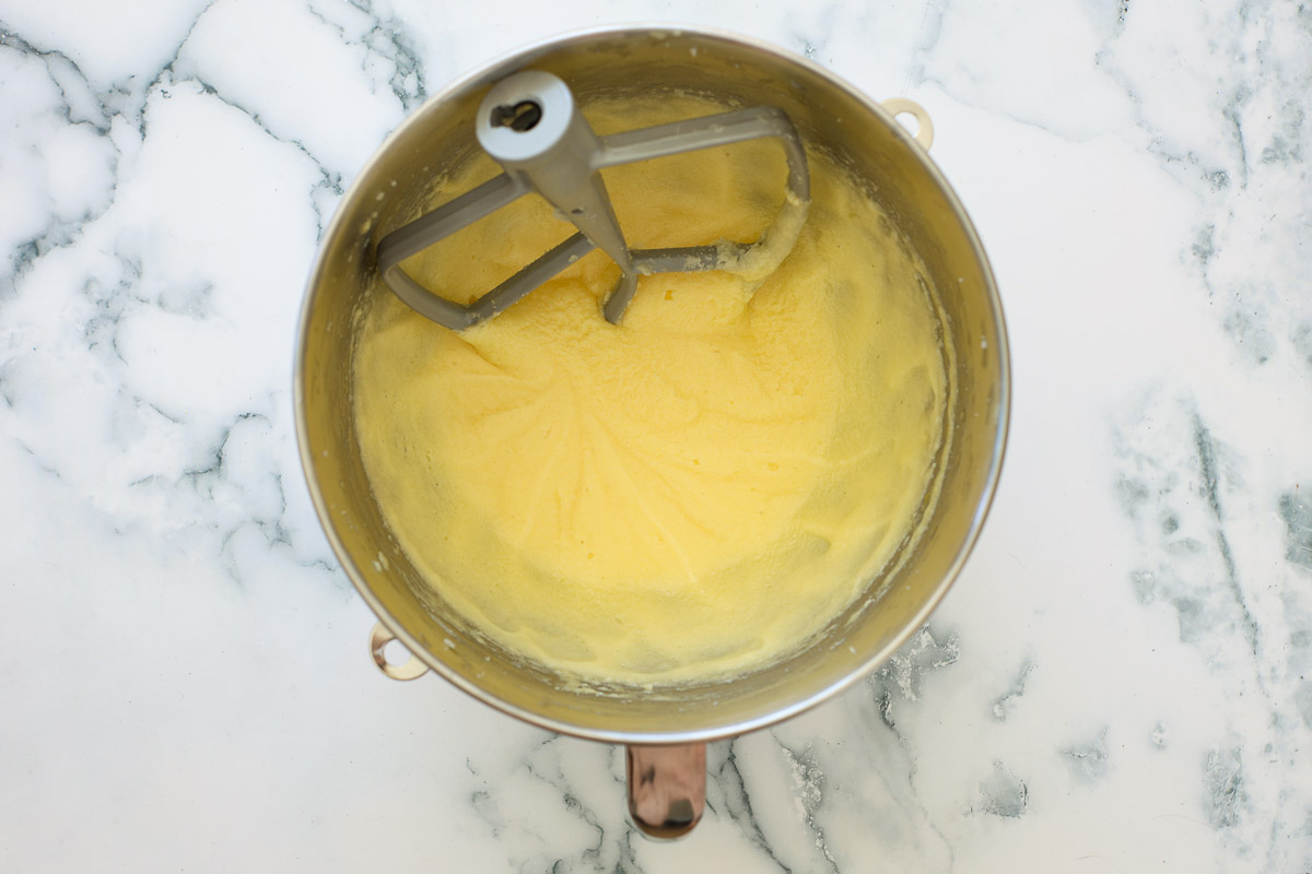 Batter after adding eggs, metal bowl, stand mixer attachment.