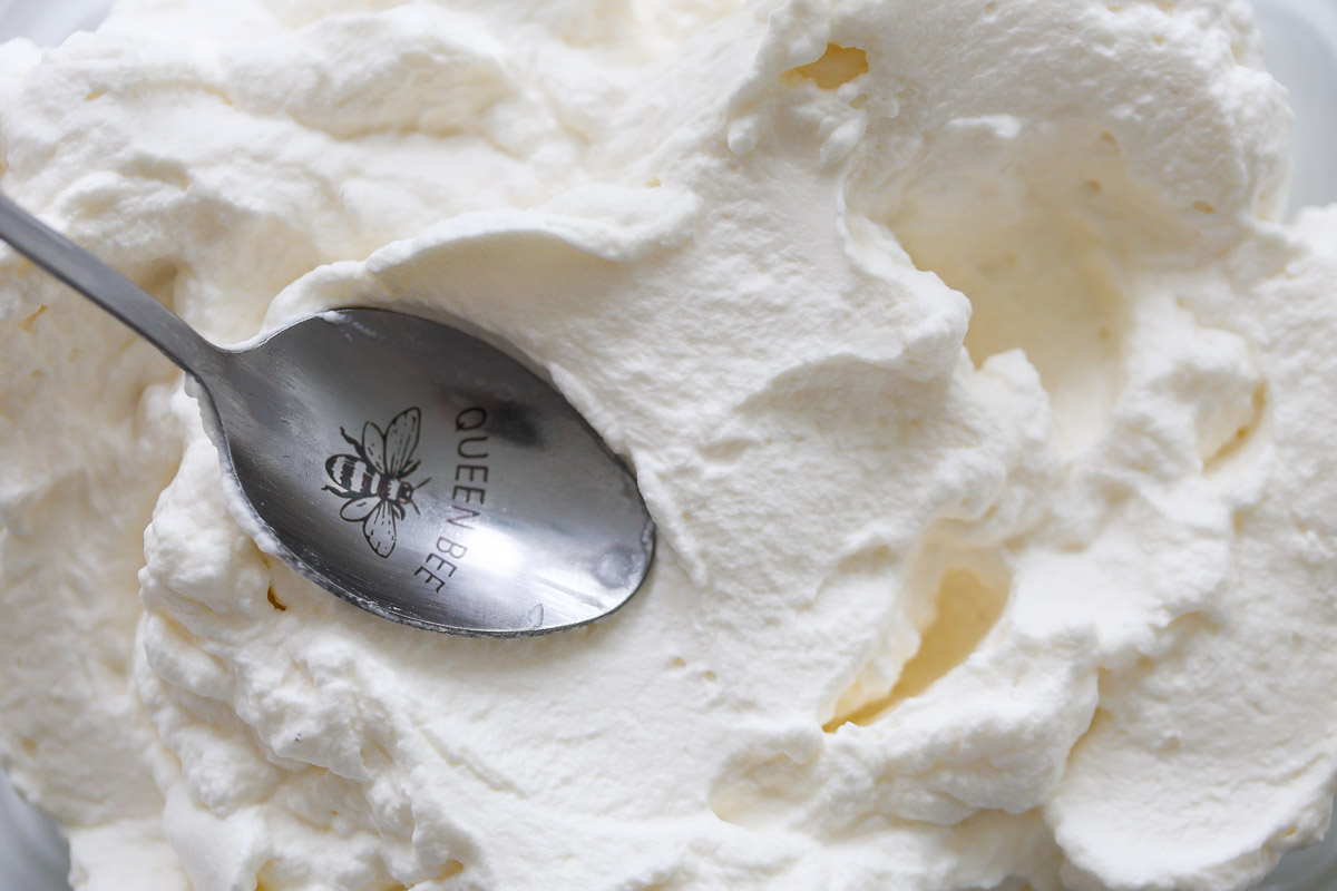 Lavender whipped cream and metal spoon.