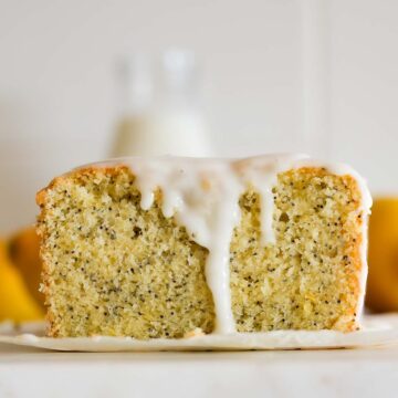 The crumb of a glazed sourdough lemon cake with poppy seeds.