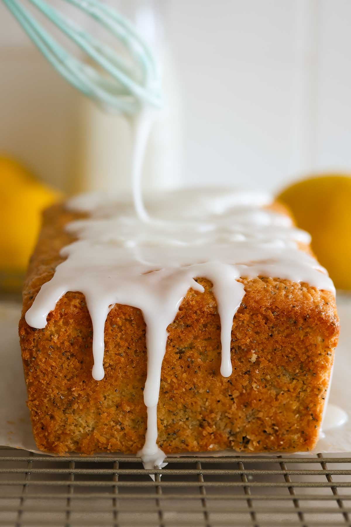 Lemon loaf with glaze drizzling over it.