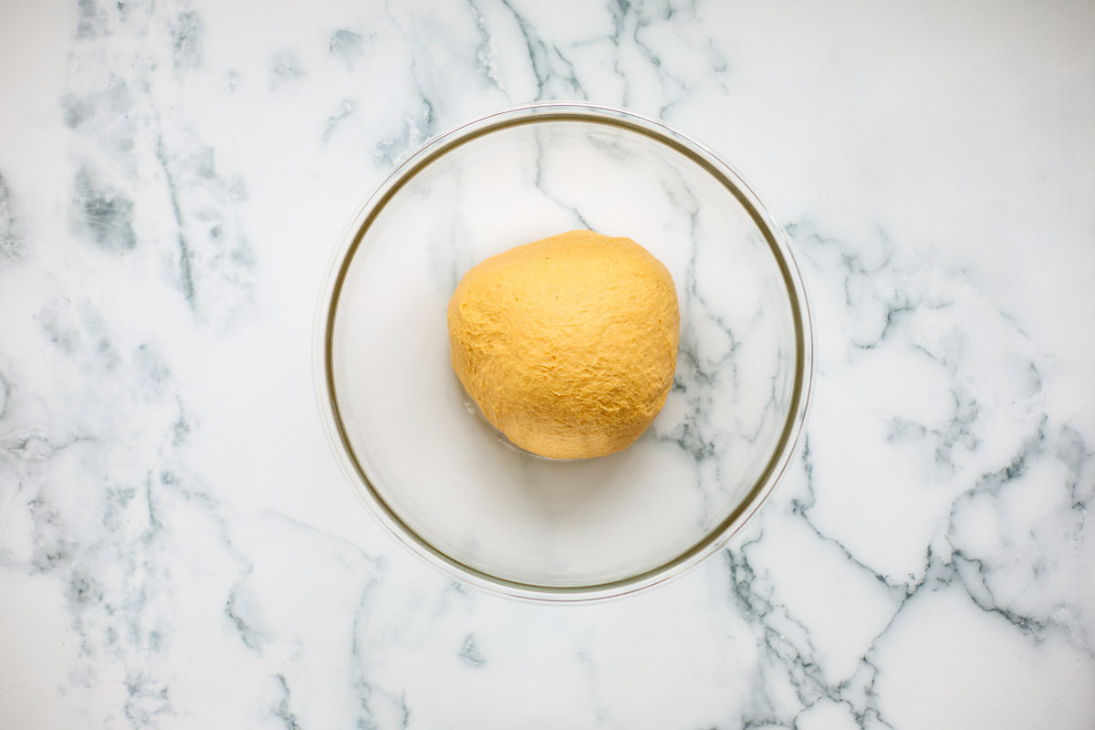 Dough inside glass bowl.