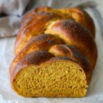A pumpkin challah loaf showing its crumb.