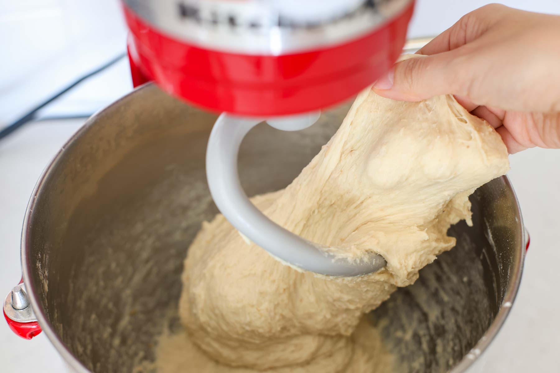 Hand stretching the dough.