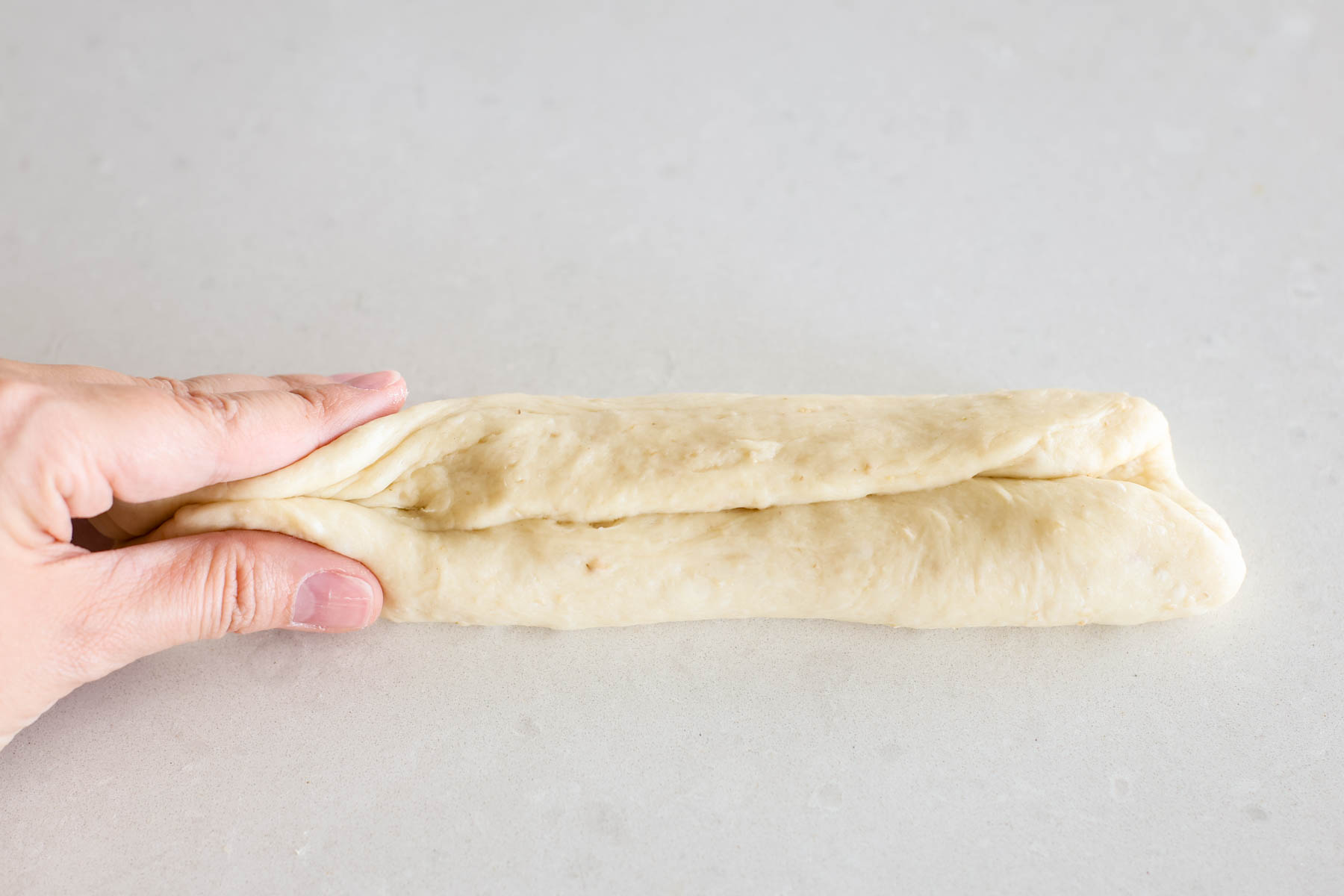 Hand shaping dough.