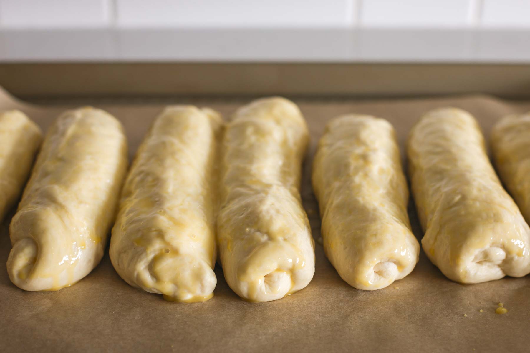 Hot dog buns after an egg wash.