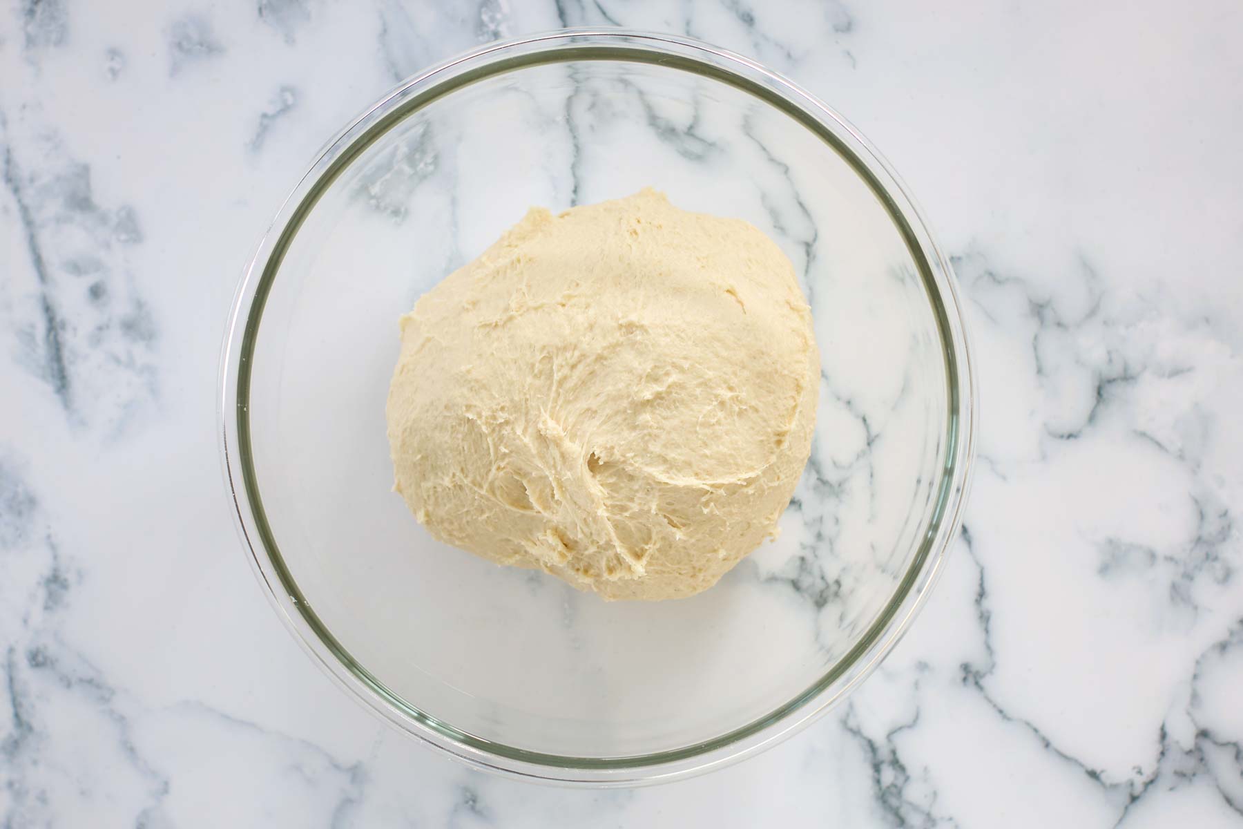 Knead dough in a glass bowl.