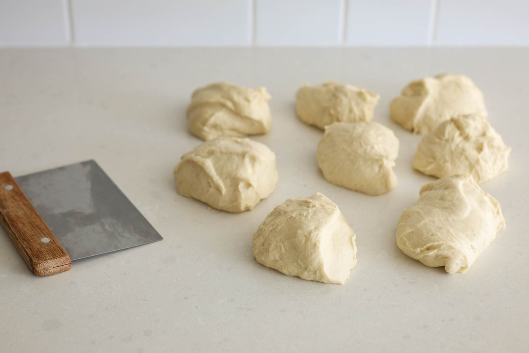 Portion dough with a scraper.