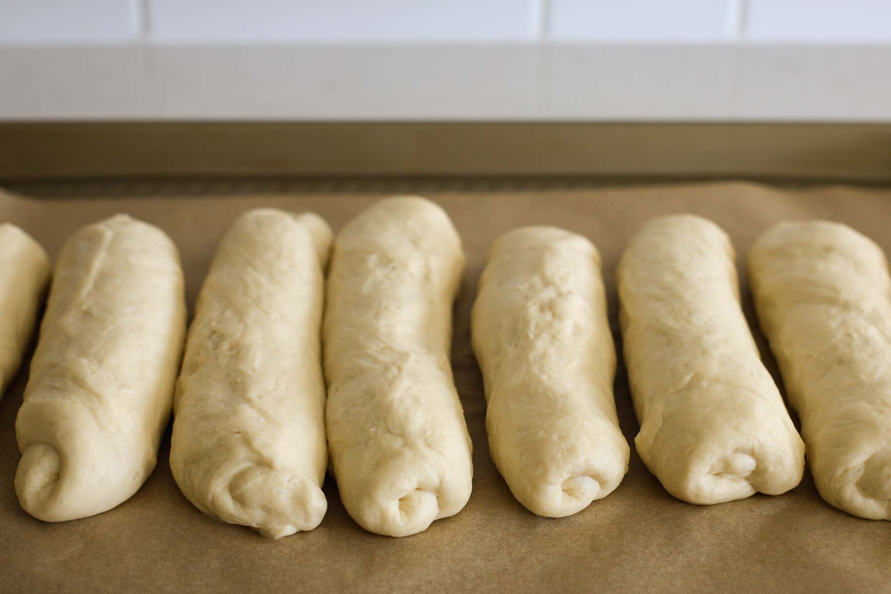 Place the hot dog rolls on a baking sheet.