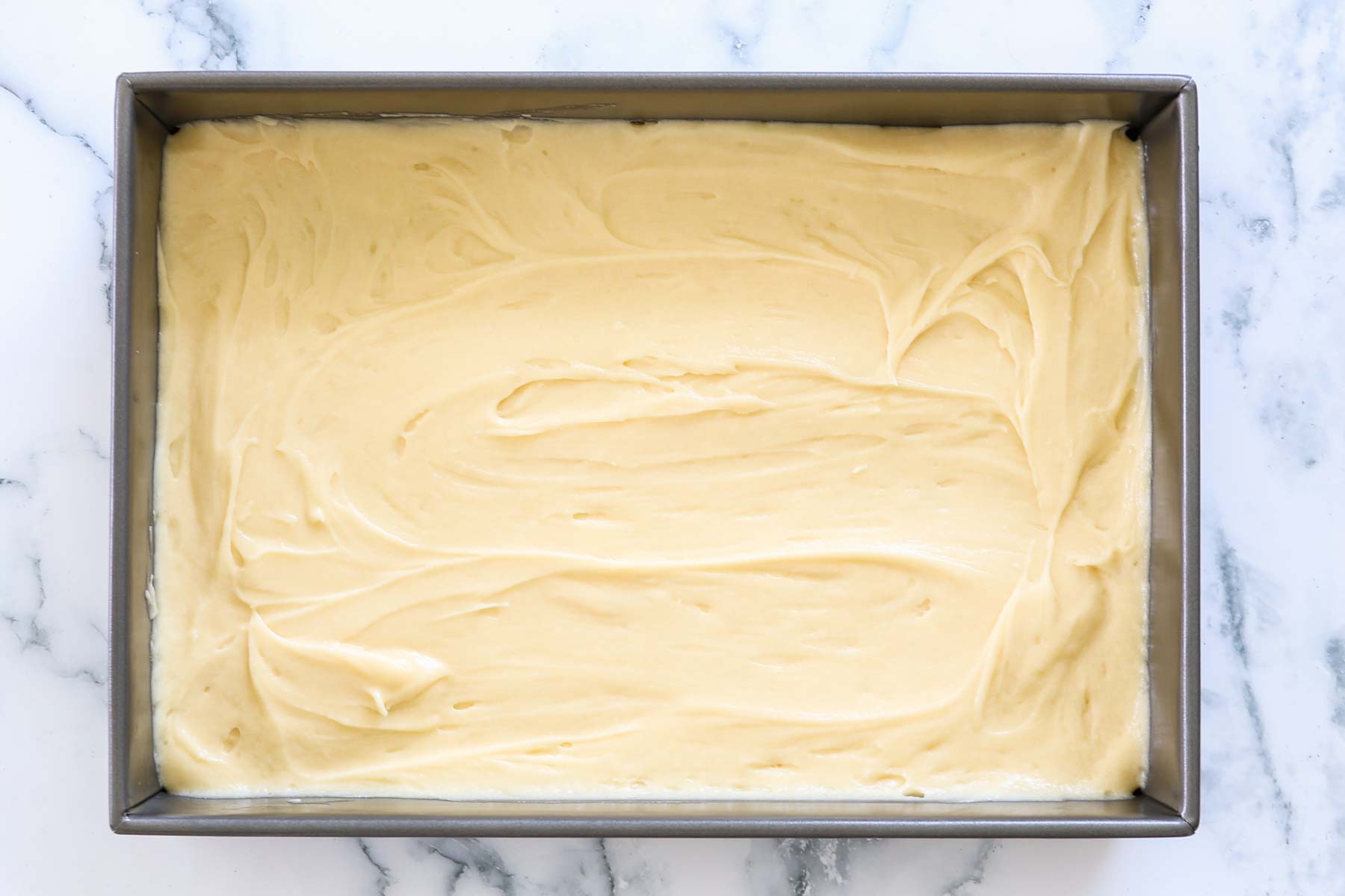 Cake bater spreaded into a baking sheet.