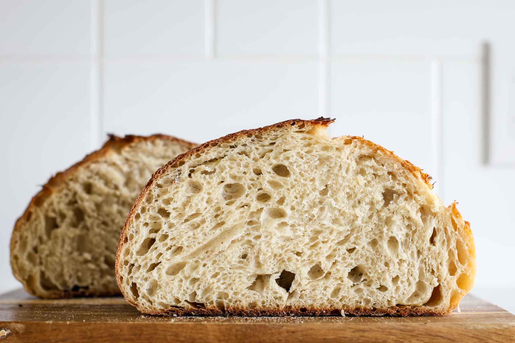 Two halves of sourdough beer bread, showing the crumb.