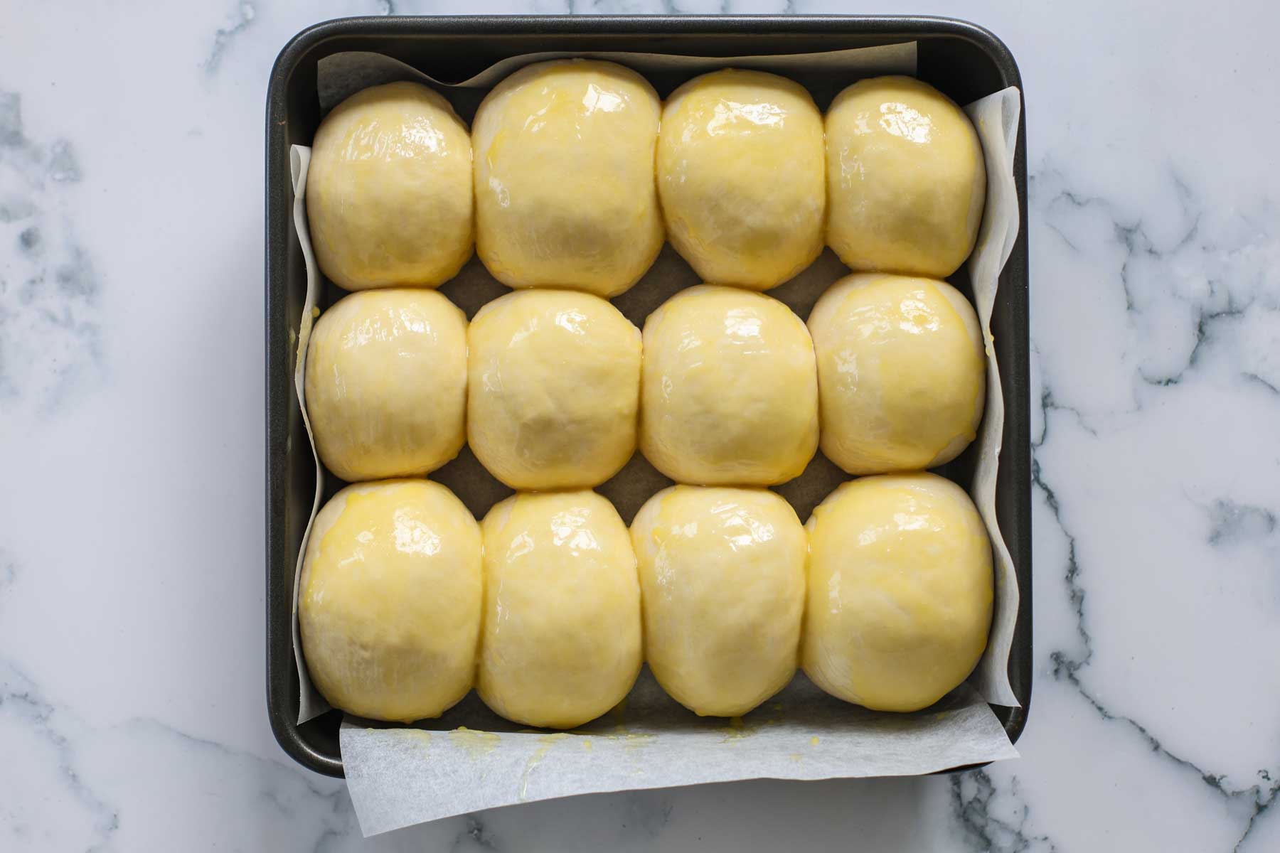 Rolls topped with the egg wash.