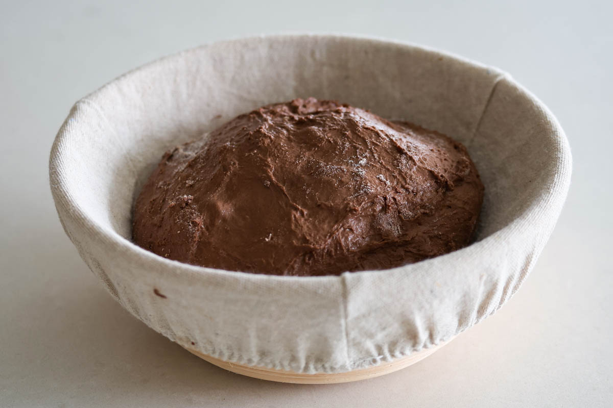 Chocolate dough into a banneton with linen cloth.