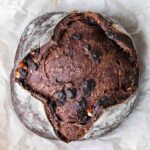 Sourdough chocolate bread boule over parchment paper.