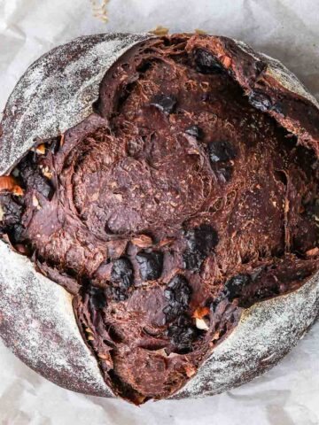 Sourdough chocolate bread boule over parchment paper.