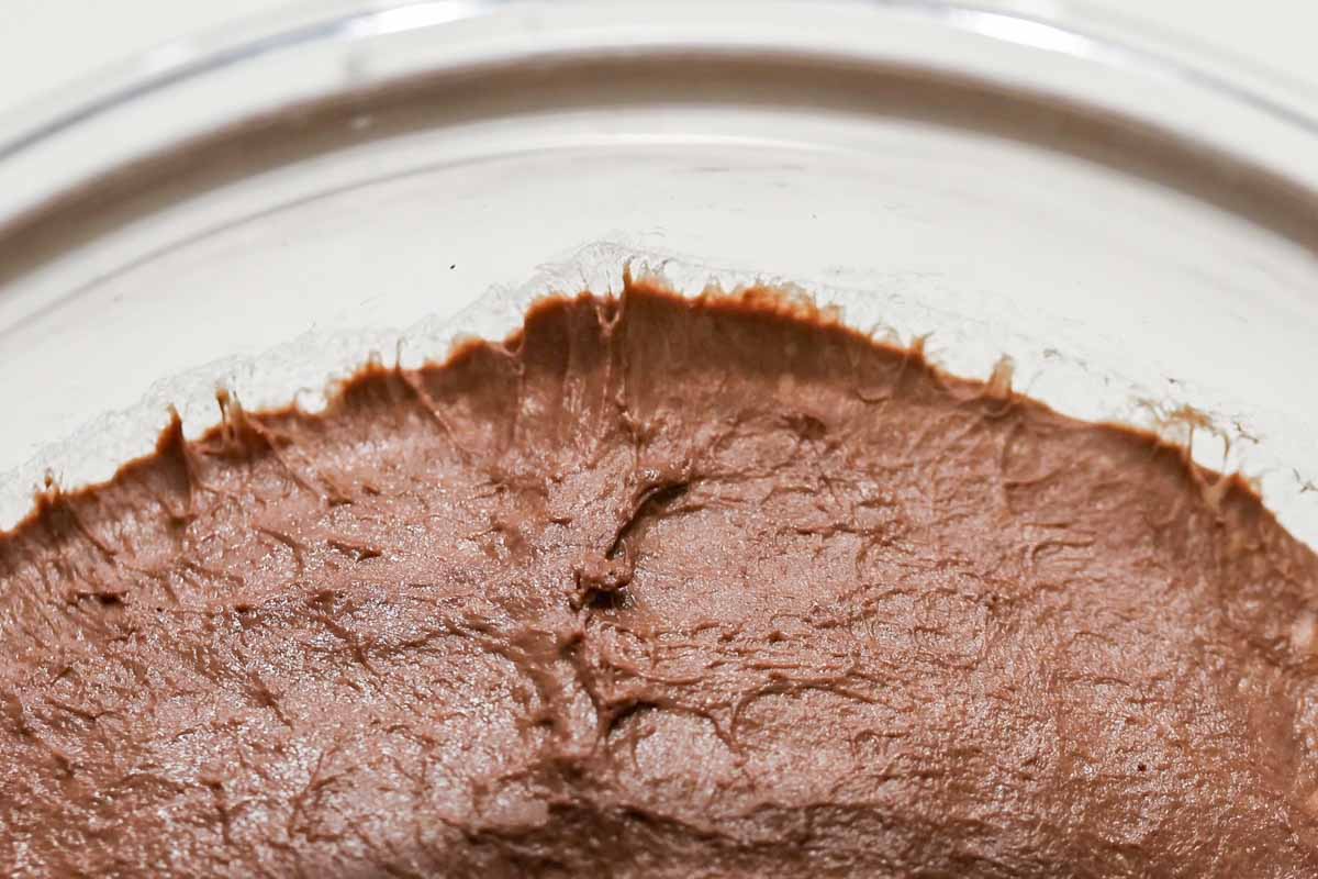 Chocolate dough sliding off the glass bowl.