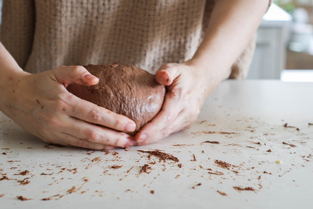 Hands to pull the dough to create more tension.