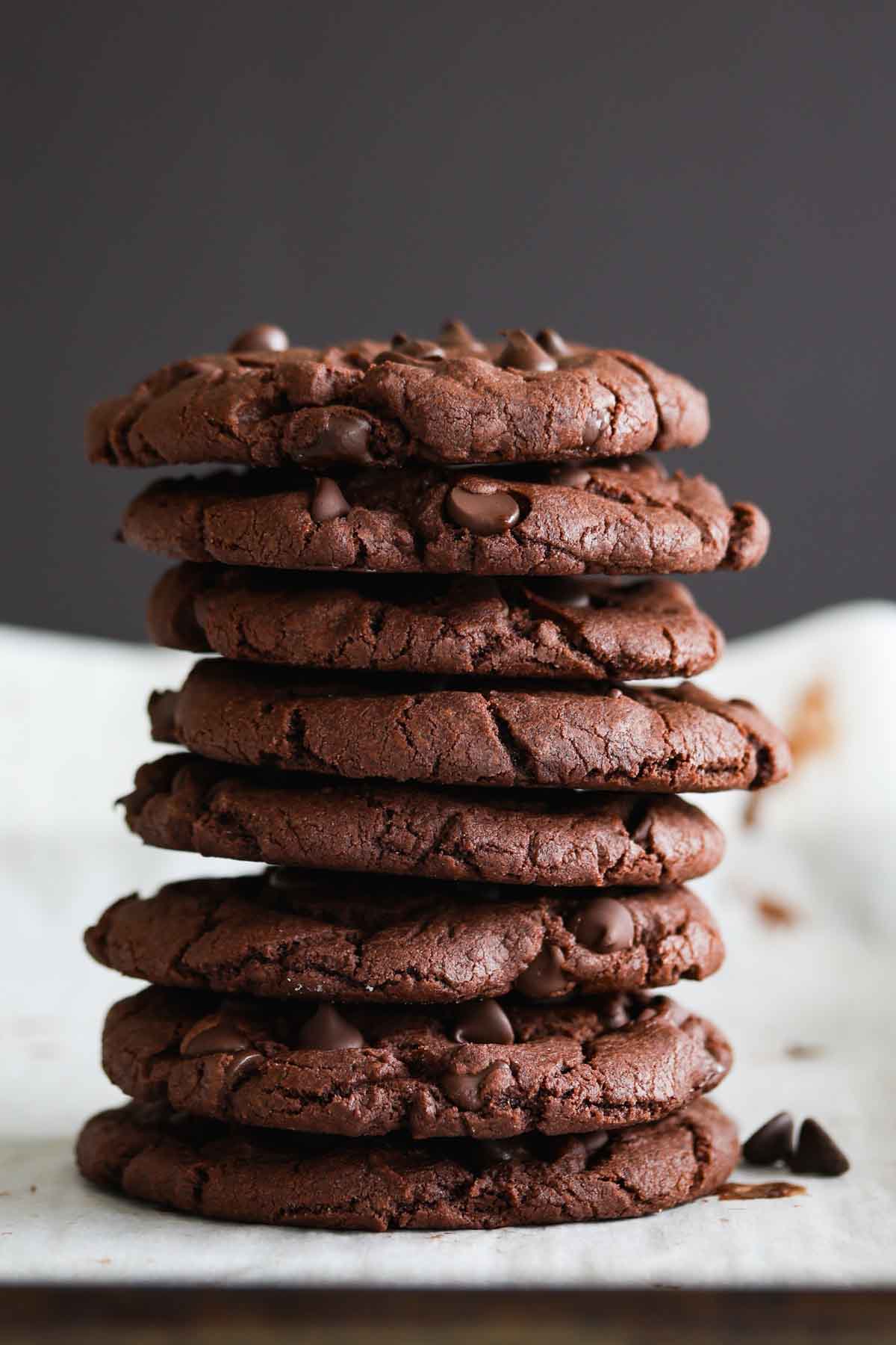 A stack of chocolate cookies with chocolate chips.