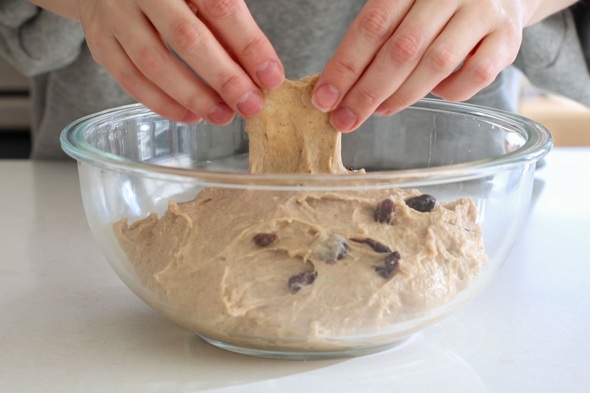 Hand pulling elastic dough.