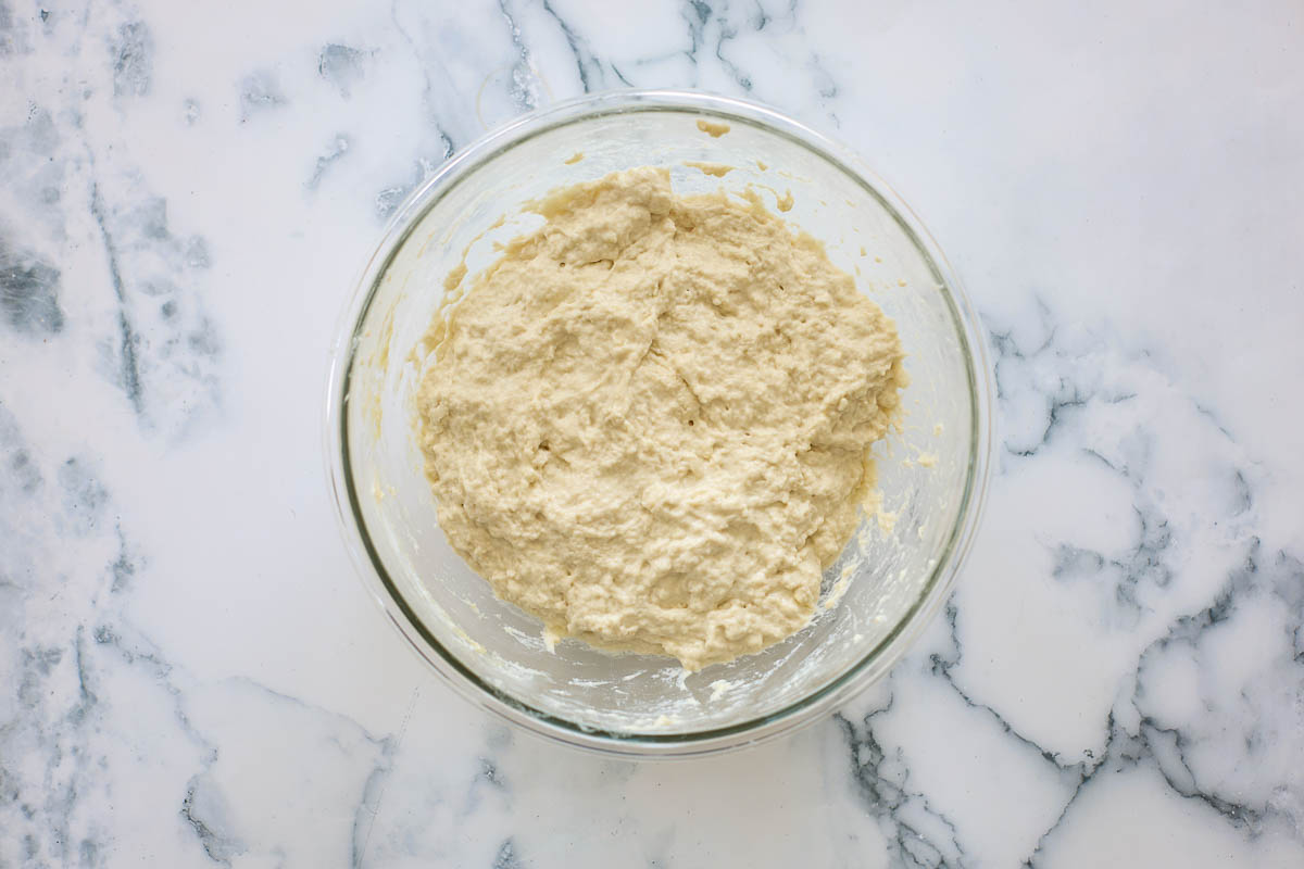 Mixed dough inside a glass bowl.