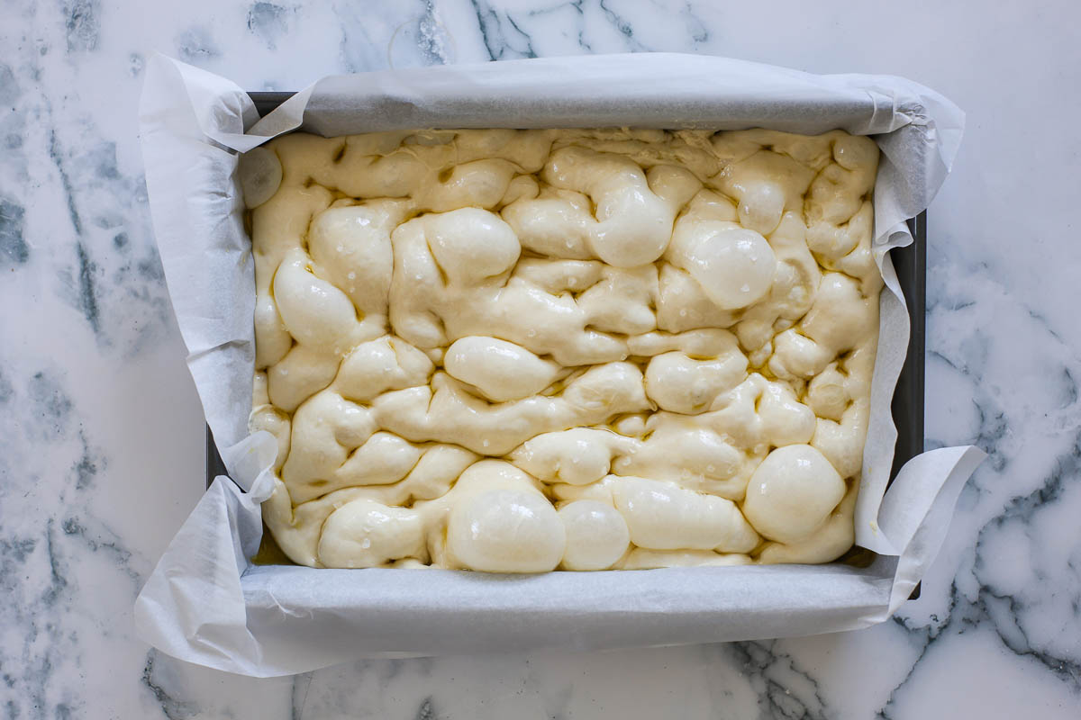 Dough with dimples, olive oil and flaky sea salt.