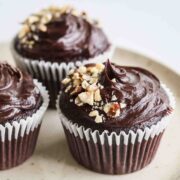 Three sourdough chocolate cupcakes with ganache topping.
