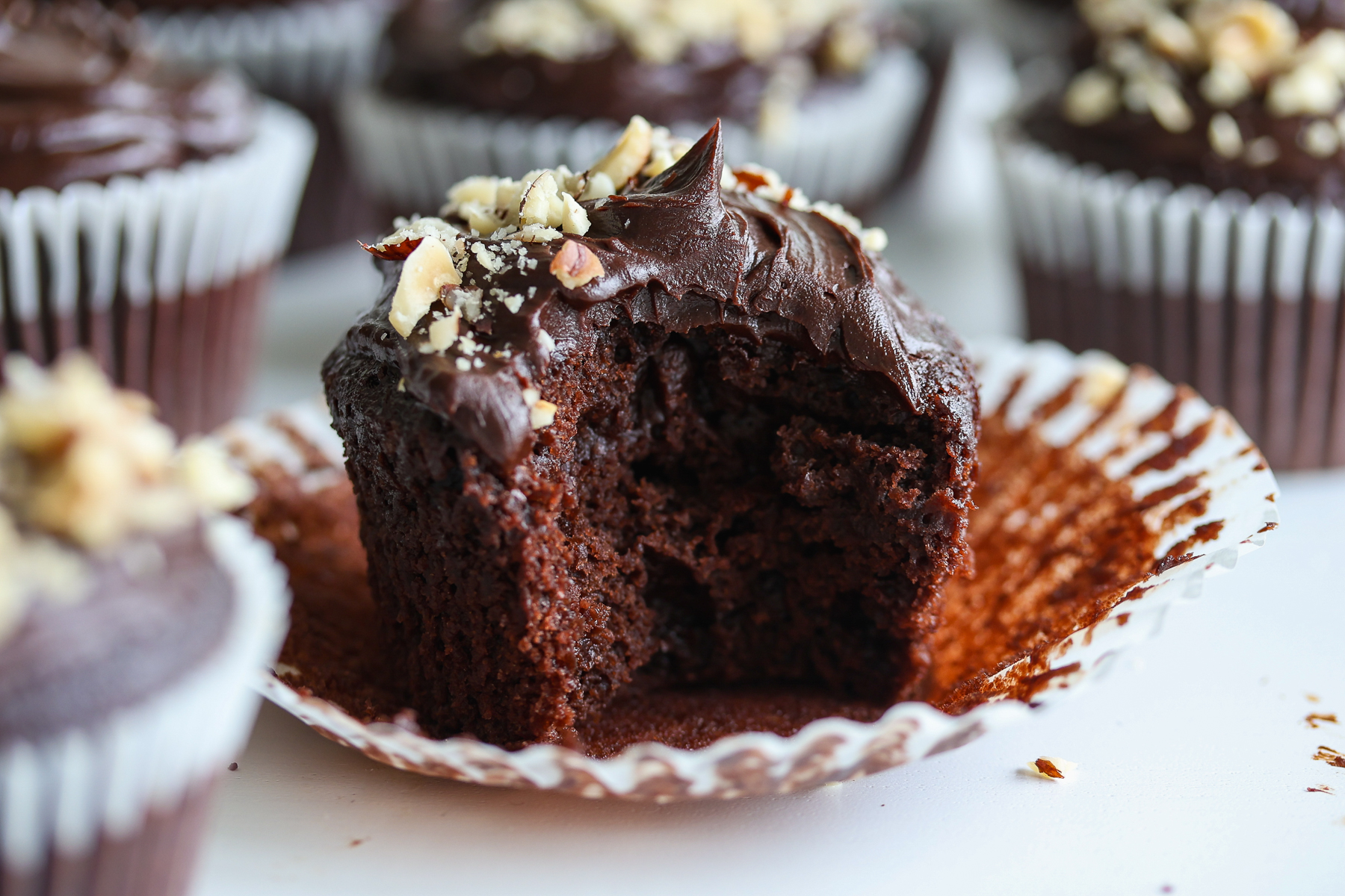Crown of a chocolate natural yeast cupcake with glaze in ganache.